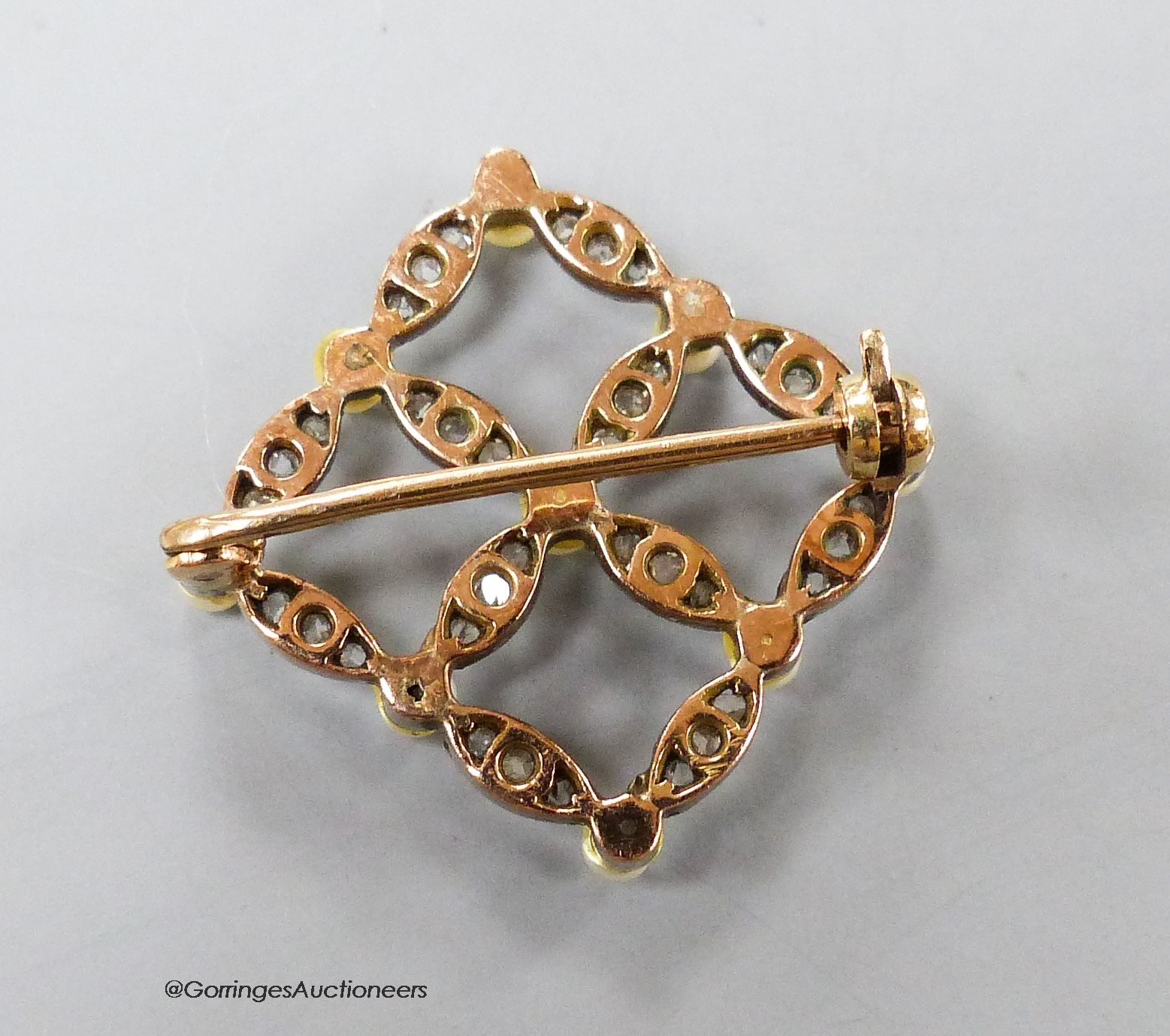 An Edwardian yellow metal, seed pearl and diamond set openwork square brooch, 19mm, gross 3.2 grams.